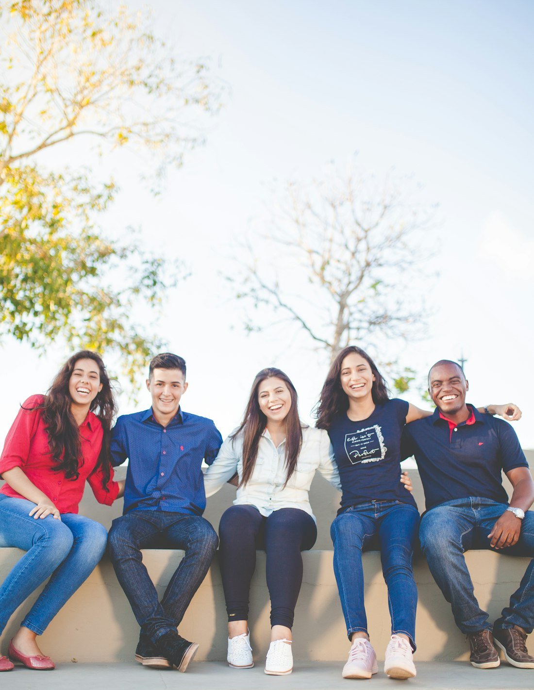 Five smiling community members sitting together